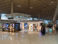 Passengers walk through a deserted Beijing Capital International Airport in Beijing, China, on December 1, 2024. (