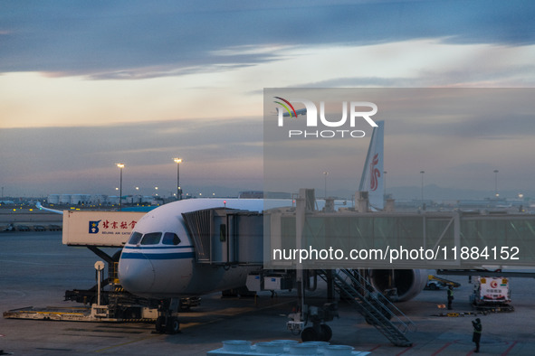 A Boeing 787-8 Dreamliner of Air China resupplies at Beijing Capital International Airport in Beijing, China, on December 1, 2024, while ano...