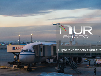 A Boeing 787-8 Dreamliner of Air China resupplies at Beijing Capital International Airport in Beijing, China, on December 1, 2024, while ano...