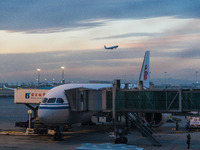 A Boeing 787-8 Dreamliner of Air China resupplies at Beijing Capital International Airport in Beijing, China, on December 1, 2024, while ano...