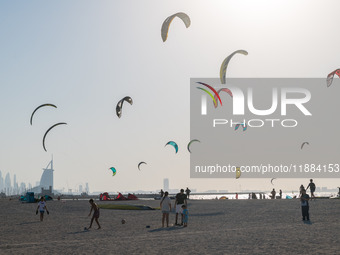 In Dubai, United Arab Emirates, kite surfers fill the sky with kites on a beach in Jumeirah. (