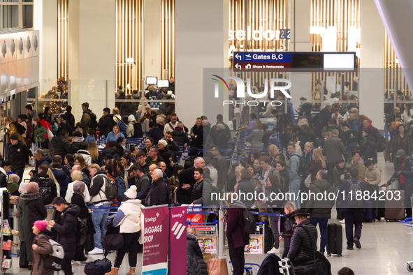 A general view of a crowd of travelers is seen at Duesseldorf Airport in Duesseldorf, Germany, on December 20, 2024, ahead of the Christmas...