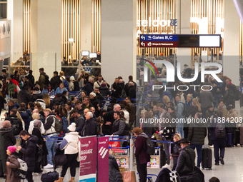 A general view of a crowd of travelers is seen at Duesseldorf Airport in Duesseldorf, Germany, on December 20, 2024, ahead of the Christmas...