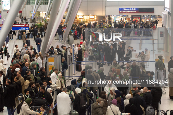 A general view of a crowd of travelers is seen at Duesseldorf Airport in Duesseldorf, Germany, on December 20, 2024, ahead of the Christmas...