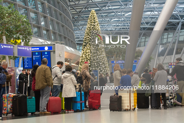 A general view of a crowd of travelers is seen at Duesseldorf Airport in Duesseldorf, Germany, on December 20, 2024, ahead of the Christmas...