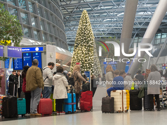 A general view of a crowd of travelers is seen at Duesseldorf Airport in Duesseldorf, Germany, on December 20, 2024, ahead of the Christmas...