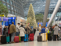 A general view of a crowd of travelers is seen at Duesseldorf Airport in Duesseldorf, Germany, on December 20, 2024, ahead of the Christmas...