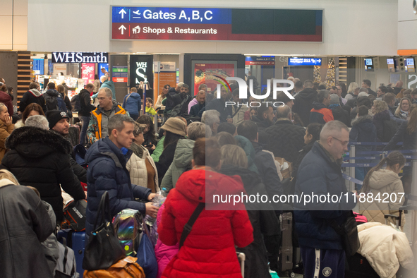 A general view of a crowd of travelers is seen at Duesseldorf Airport in Duesseldorf, Germany, on December 20, 2024, ahead of the Christmas...