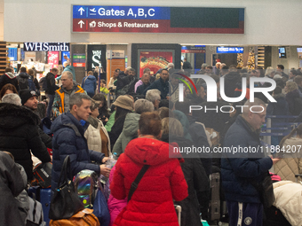 A general view of a crowd of travelers is seen at Duesseldorf Airport in Duesseldorf, Germany, on December 20, 2024, ahead of the Christmas...