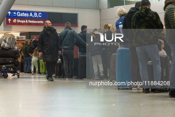 A general view of a crowd of travelers is seen at Duesseldorf Airport in Duesseldorf, Germany, on December 20, 2024, ahead of the Christmas...