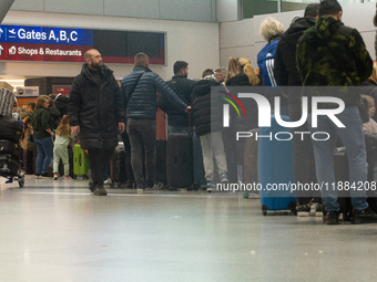 A general view of a crowd of travelers is seen at Duesseldorf Airport in Duesseldorf, Germany, on December 20, 2024, ahead of the Christmas...