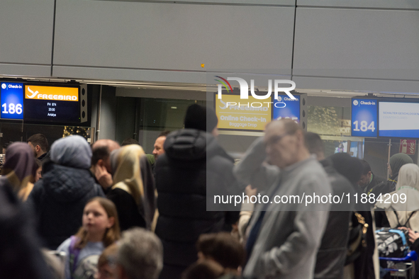 A general view of a crowd of travelers is seen at Duesseldorf Airport in Duesseldorf, Germany, on December 20, 2024, ahead of the Christmas...