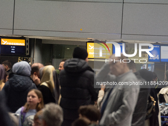 A general view of a crowd of travelers is seen at Duesseldorf Airport in Duesseldorf, Germany, on December 20, 2024, ahead of the Christmas...