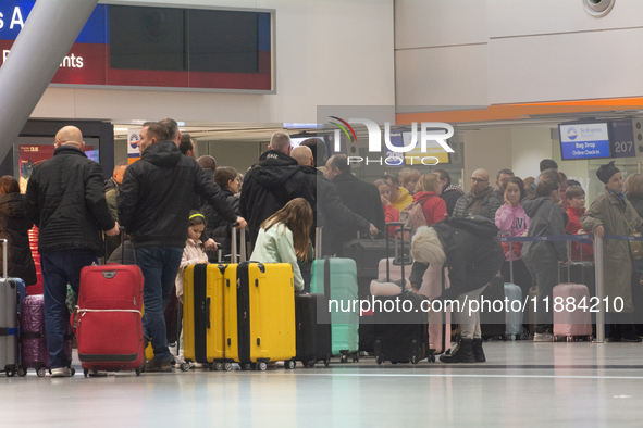 A general view of a crowd of travelers is seen at Duesseldorf Airport in Duesseldorf, Germany, on December 20, 2024, ahead of the Christmas...