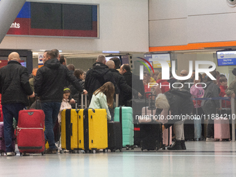 A general view of a crowd of travelers is seen at Duesseldorf Airport in Duesseldorf, Germany, on December 20, 2024, ahead of the Christmas...