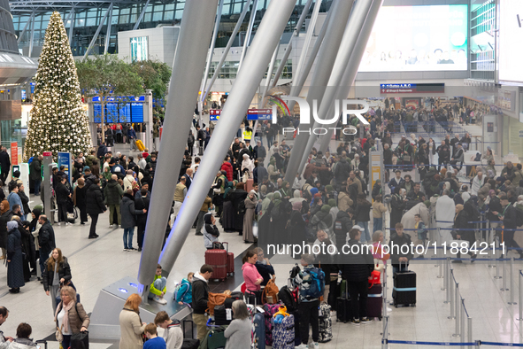 A general view of a crowd of travelers is seen at Duesseldorf Airport in Duesseldorf, Germany, on December 20, 2024, ahead of the Christmas...