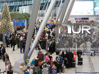 A general view of a crowd of travelers is seen at Duesseldorf Airport in Duesseldorf, Germany, on December 20, 2024, ahead of the Christmas...