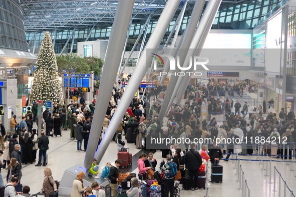 A general view of a crowd of travelers is seen at Duesseldorf Airport in Duesseldorf, Germany, on December 20, 2024, ahead of the Christmas...