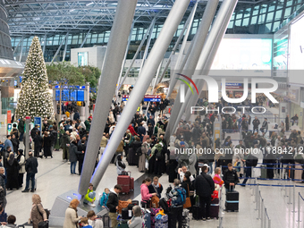 A general view of a crowd of travelers is seen at Duesseldorf Airport in Duesseldorf, Germany, on December 20, 2024, ahead of the Christmas...