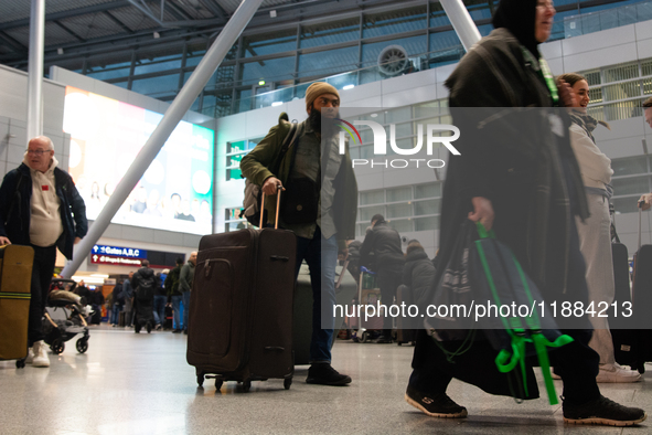 A general view of a crowd of travelers is seen at Duesseldorf Airport in Duesseldorf, Germany, on December 20, 2024, ahead of the Christmas...