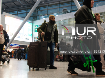 A general view of a crowd of travelers is seen at Duesseldorf Airport in Duesseldorf, Germany, on December 20, 2024, ahead of the Christmas...