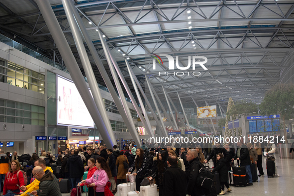 A general view of a crowd of travelers is seen at Duesseldorf Airport in Duesseldorf, Germany, on December 20, 2024, ahead of the Christmas...