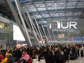 A general view of a crowd of travelers is seen at Duesseldorf Airport in Duesseldorf, Germany, on December 20, 2024, ahead of the Christmas...