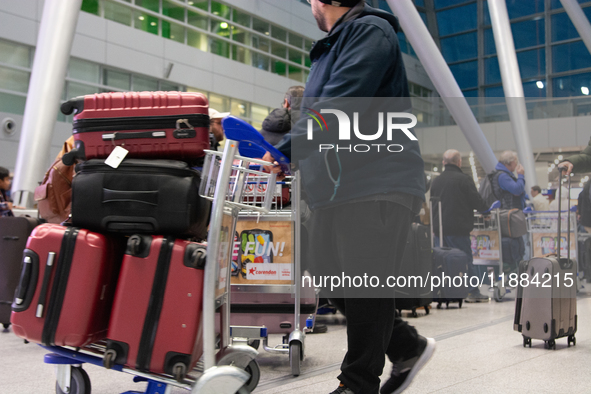 A general view of a crowd of travelers is seen at Duesseldorf Airport in Duesseldorf, Germany, on December 20, 2024, ahead of the Christmas...