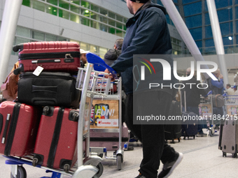 A general view of a crowd of travelers is seen at Duesseldorf Airport in Duesseldorf, Germany, on December 20, 2024, ahead of the Christmas...