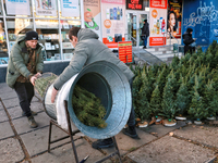 Men pack a Christmas tree in Odesa, Ukraine, on December 19, 2024. (