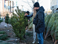 People look at the Christmas tree in Odesa, Ukraine, on December 19, 2024. (