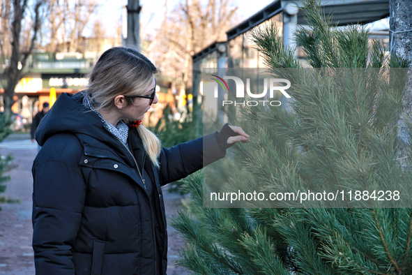 A woman looks at a Christmas tree in Odesa, Ukraine, on December 19, 2024. 