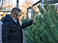 A woman looks at a Christmas tree in Odesa, Ukraine, on December 19, 2024. (