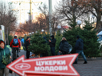 In Odesa, Ukraine, on December 19, 2024, people look at the Christmas trees sold on a local street. (