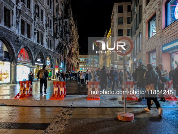 Pedestrians navigate through the safety barrier access point to the Christmas Market at Marienplatz in Munich, Bavaria, Germany, on December...