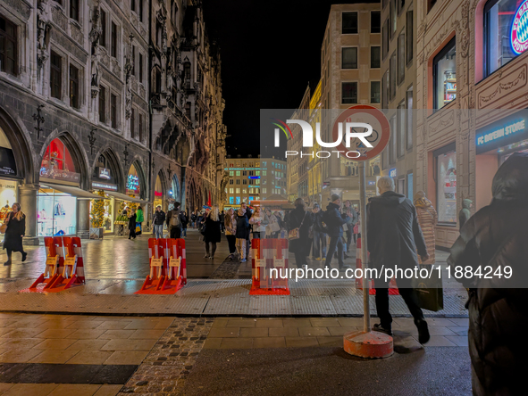 Pedestrians navigate through the safety barrier access point to the Christmas Market at Marienplatz in Munich, Bavaria, Germany, on December...