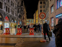 Pedestrians navigate through the safety barrier access point to the Christmas Market at Marienplatz in Munich, Bavaria, Germany, on December...