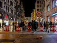 Pedestrians navigate through the safety barrier access point to the Christmas Market at Marienplatz in Munich, Bavaria, Germany, on December...