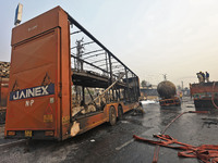 Firefighters douse the fire at the site of the accident after a tanker loaded with LPG collides with other vehicles and catches fire on the...