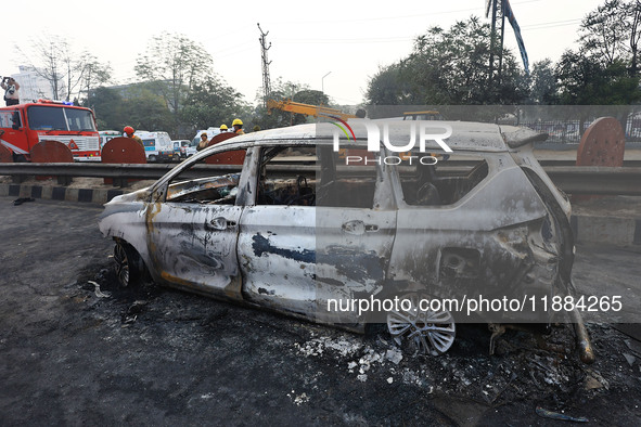 Burnt debris of vehicles is at the site of the accident after a tanker loaded with LPG collides with some other vehicles and catches fire on...