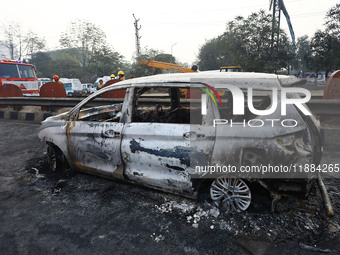 Burnt debris of vehicles is at the site of the accident after a tanker loaded with LPG collides with some other vehicles and catches fire on...