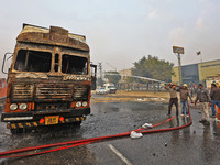 Firefighters douse the fire at the site of the accident after a tanker loaded with LPG collides with other vehicles and catches fire on the...