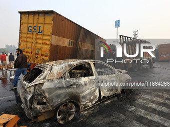 Burnt debris of vehicles is at the site of the accident after a tanker loaded with LPG collides with some other vehicles and catches fire on...