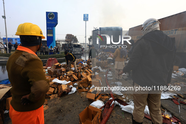 Burnt debris of vehicles is at the site of the accident after a tanker loaded with LPG collides with some other vehicles and catches fire on...