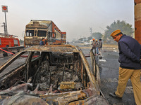 Firefighters douse the fire at the site of the accident after a tanker loaded with LPG collides with other vehicles and catches fire on the...