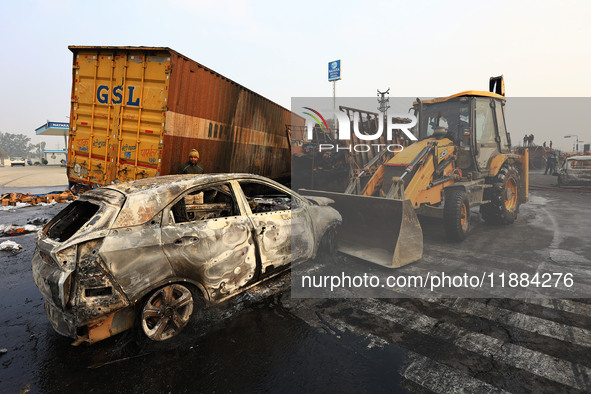 Burnt debris of vehicles is at the site of the accident after a tanker loaded with LPG collides with some other vehicles and catches fire on...