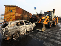 Burnt debris of vehicles is at the site of the accident after a tanker loaded with LPG collides with some other vehicles and catches fire on...