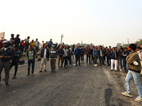 Local residents gather at the site of the accident after a tanker loaded with LPG collides with other vehicles and catches fire on the Jaipu...