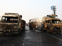 Firefighters douse the fire at the site of the accident after a tanker loaded with LPG collides with other vehicles and catches fire on the...