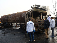 FSL team members inspect the site of the accident after a tanker loaded with LPG collides with some other vehicles and catches fire on the J...